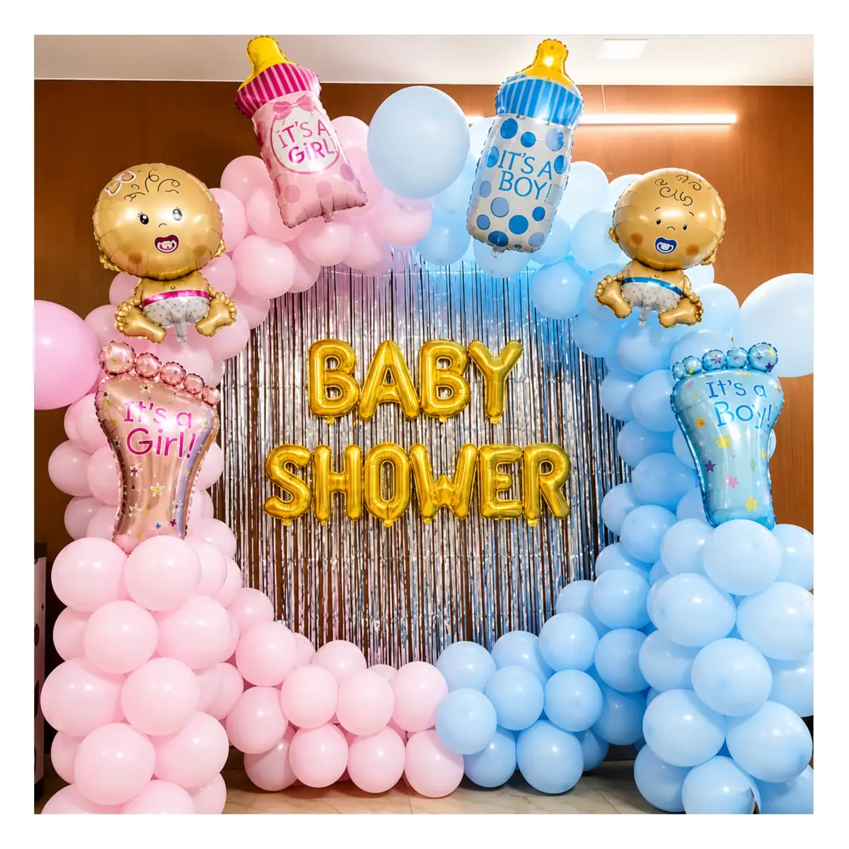 Pink and blue balloon arch around a Baby Shower foil banner with baby bottle balloons