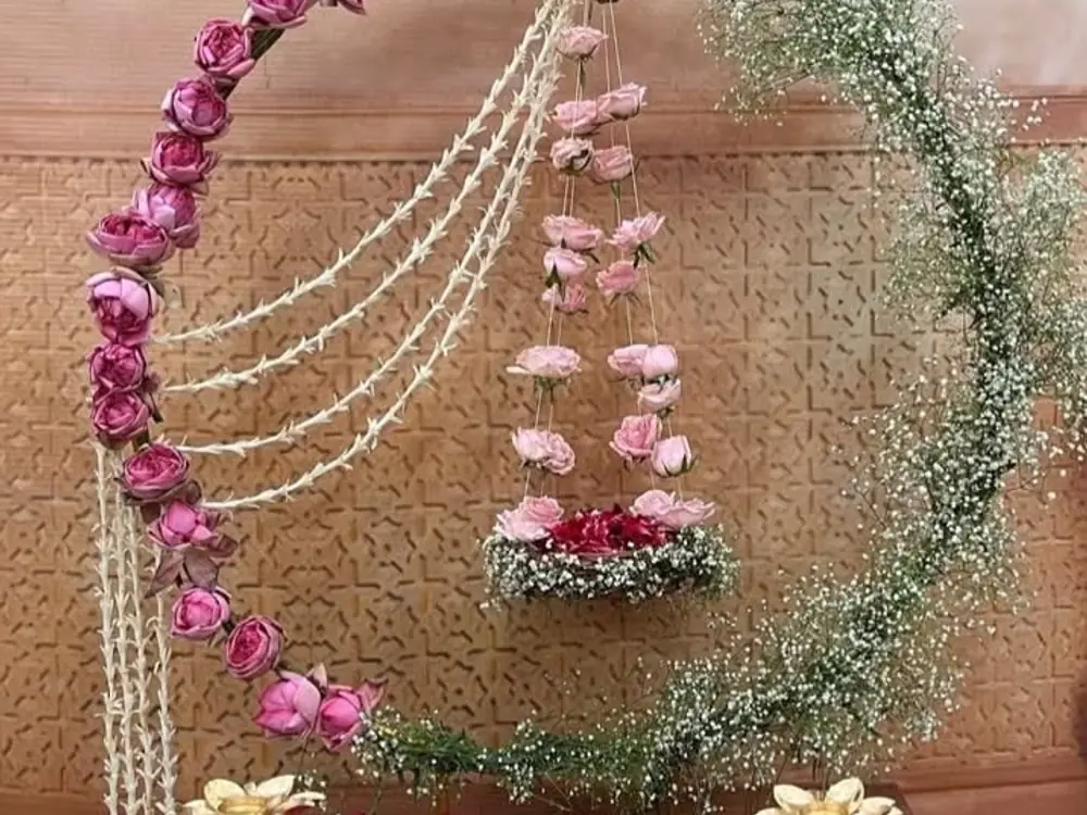 Hanging floral jhula with pink roses, pearl strings and a ring of gypsophila
