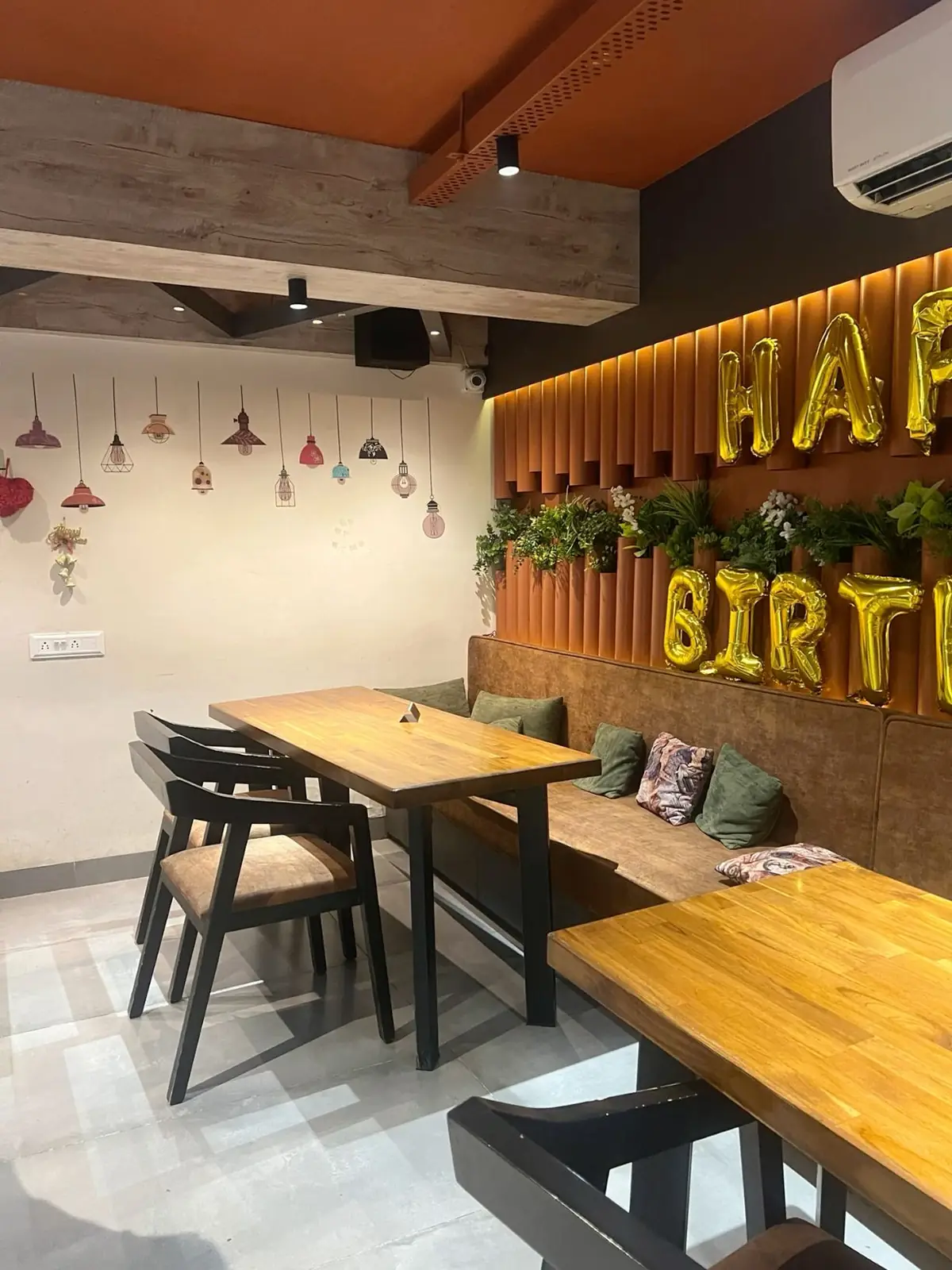 Cafe birthday corner with heart balloon backdrop and small celebration table