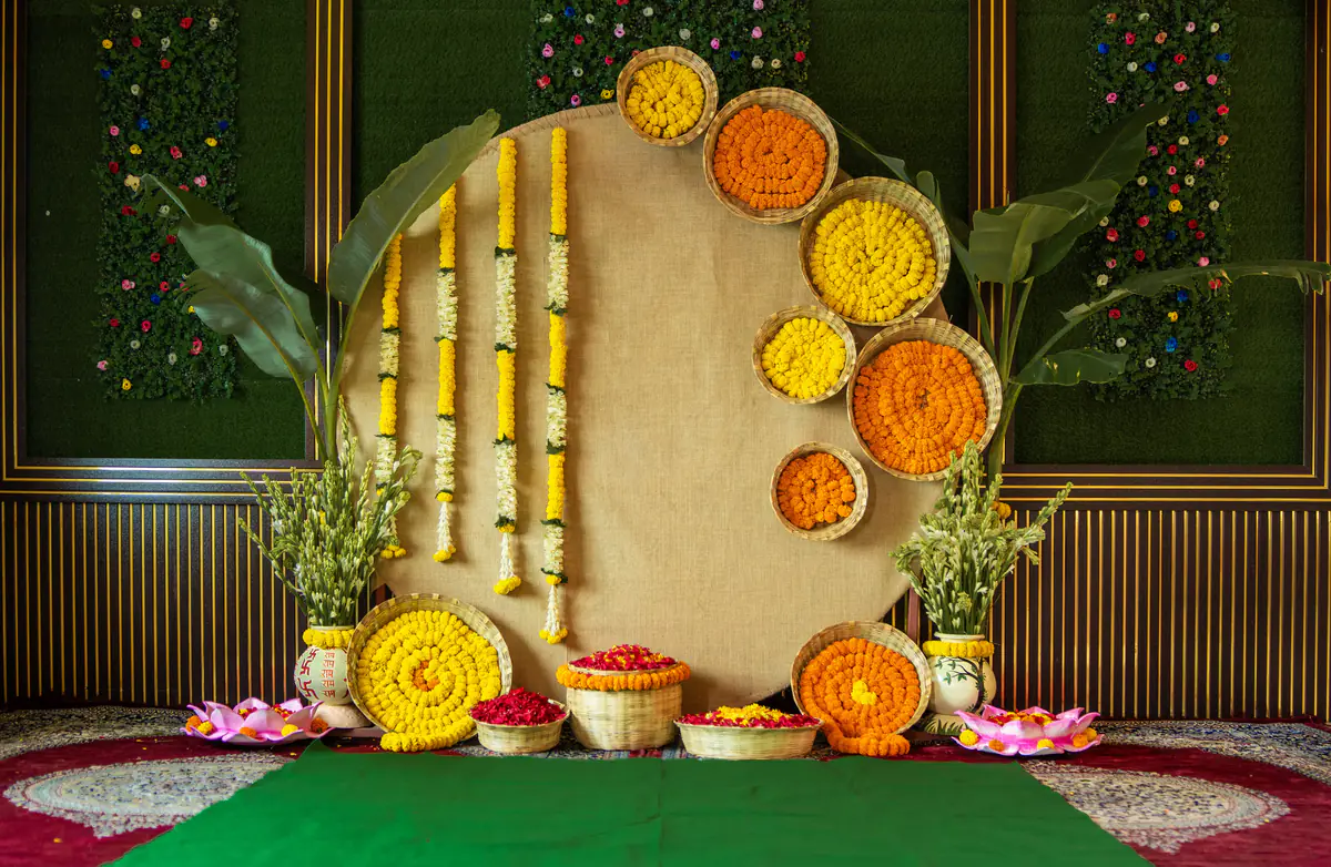 A floral annaprashan backdrop with marigold discs