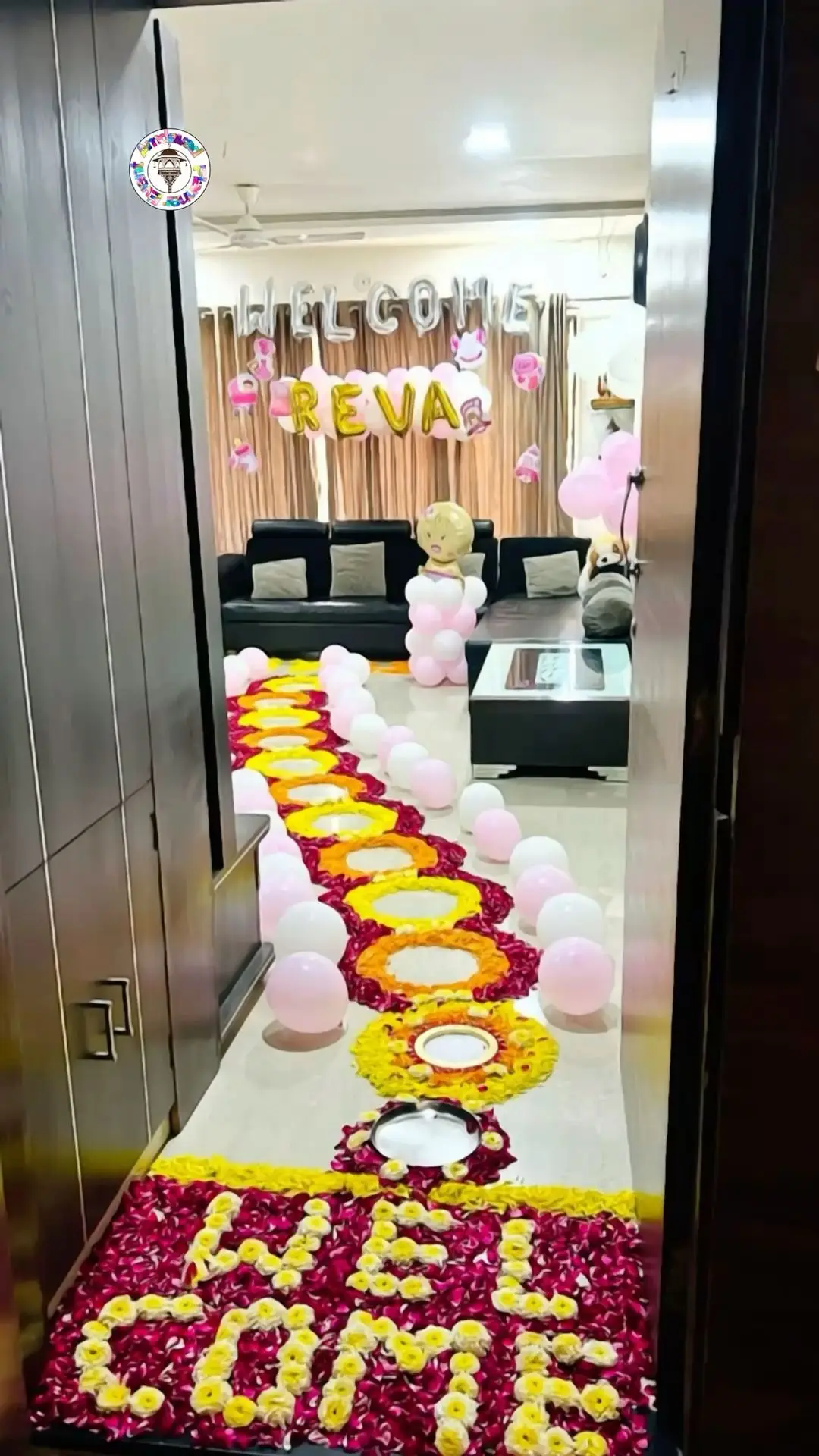A hallway with a WELCOME spelt in marigold and rose petals on the floor