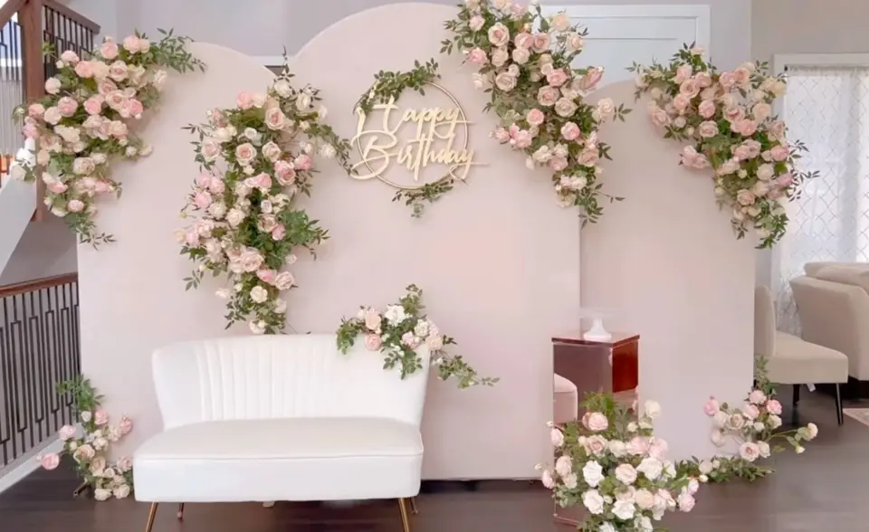 White floral backdrop panels with a sofa for a small event