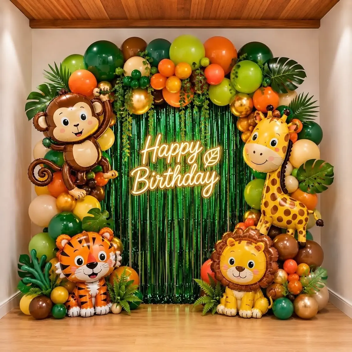 A jungle theme birthday backdrop with a monkey, giraffe, lion and tiger balloon arch